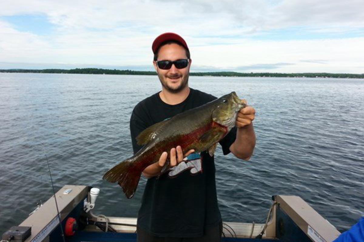 man holding a fish caught on Lake Simcoe