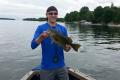 man holding a fish caught on Lake Simcoe