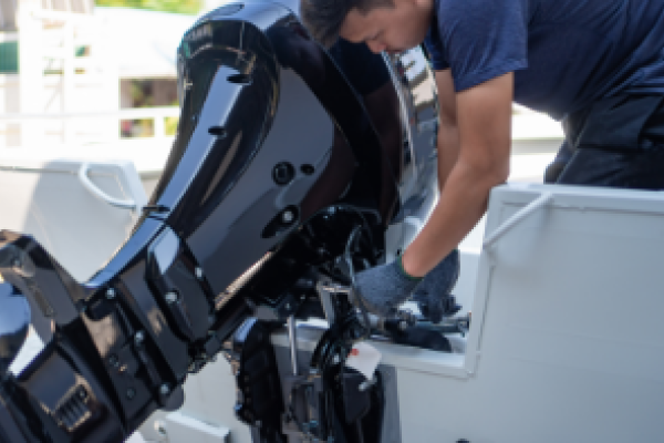 Marine technician fixing an outboard engine.