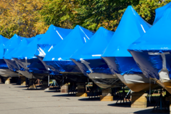 Boats shrink wrapped on land for winter storage