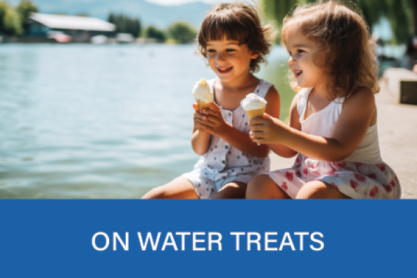 Two young girls eating ice cream on a dock on Lake Simcoe